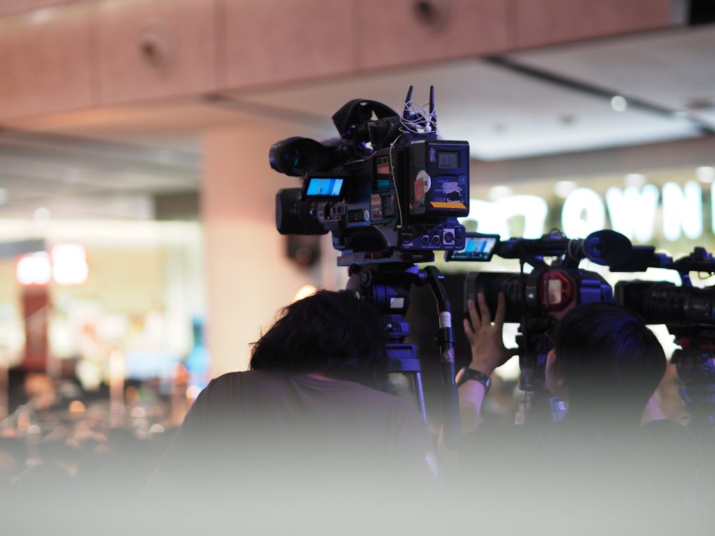Men standing on camera at the event AV
